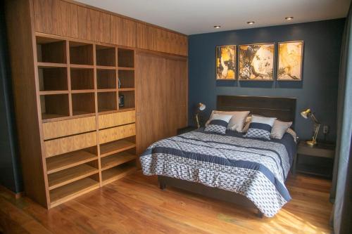 a bedroom with a bed and a large closet at Business SUITES KEPLER in Mexico City