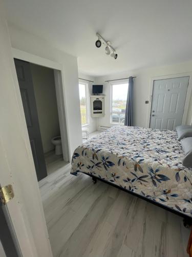 a bedroom with a bed and a bathroom at Amherst Cove Cottage # 5 in Borden-Carleton
