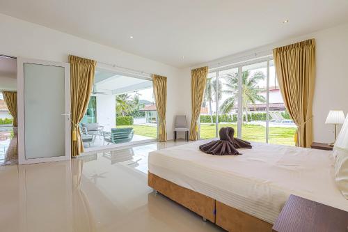 a bedroom with a large bed and a large window at Amazing Private 6 Bedroom Pool Villa ED60 in Khao Tao