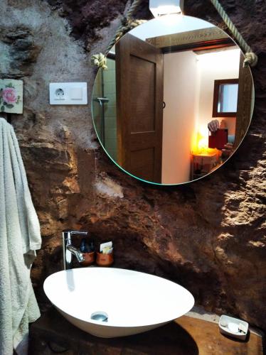 a bathroom with a sink and a mirror at Casa Fabiana in Montenegro de Cameros
