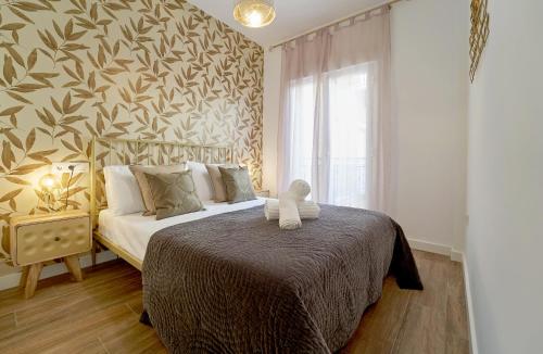 a bedroom with a bed with a teddy bear on it at El Coso Boutique Lucena in Lucena