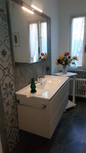 a bathroom with a sink and a mirror at House in The Calm Nature of Prosecco Valley in Revine Lago