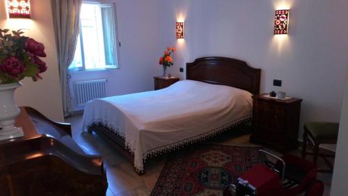 a bedroom with a bed and two tables and a window at House in The Calm Nature of Prosecco Valley in Revine Lago