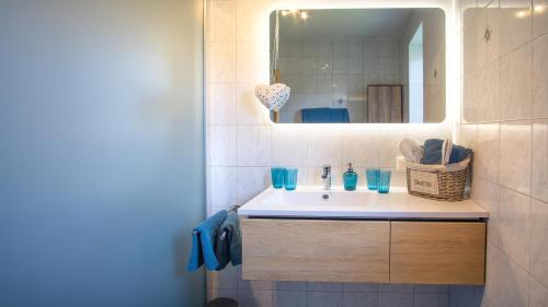 a bathroom with a sink and a mirror at Stubaier Bauern Appartement in Telfes im Stubai