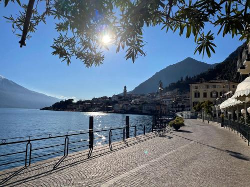 a walkway next to a body of water at B&B Casa Limone in Limone sul Garda