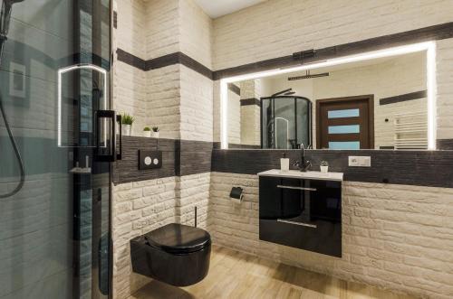 a bathroom with a sink and a mirror at Więckowskiego Apartment in Łódź