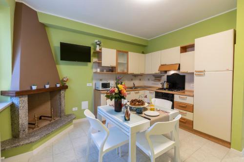 a kitchen with a table and chairs in a kitchen at DOLF - Villa Elisa in Tolentino