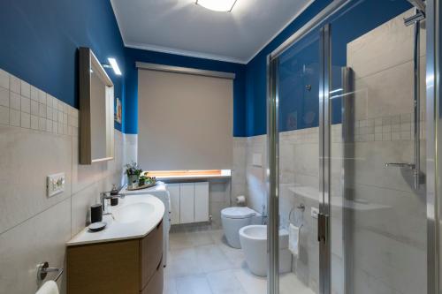 a bathroom with a toilet and a sink and a shower at DOLF - Villa Elisa in Tolentino