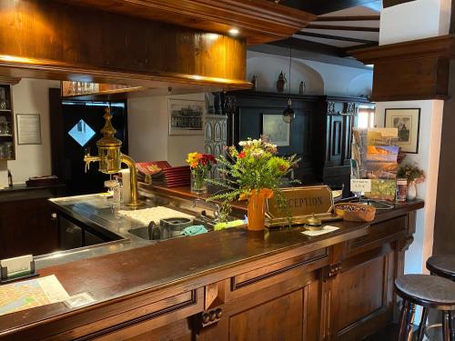 a kitchen counter with a sink and flowers on it at Norddeutscher Hof in Stralsund