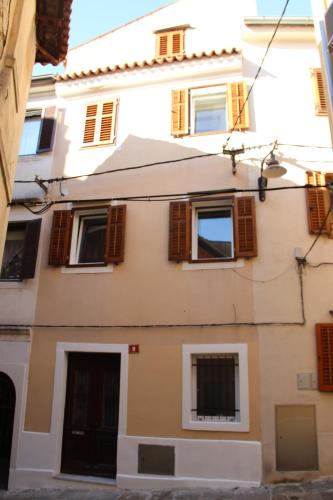 a building with brown shuttered windows on it at Lighthouse.Izola in Izola