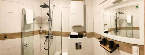 a bathroom with a shower with a glass door at apartament Forest Karpacz in Karpacz