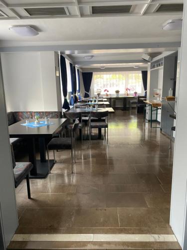 a dining room with tables and chairs in it at Hotel Braunlage in Braunlage