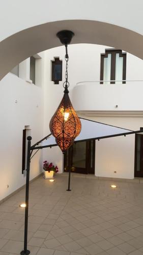 aendant light hanging from the ceiling of a building at Hotel Villa Ionia in Avola