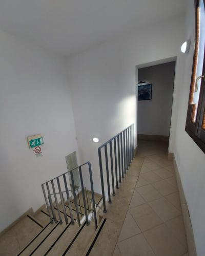 a stairway with a wooden bench in a hallway at Hotel Villa Ionia in Avola
