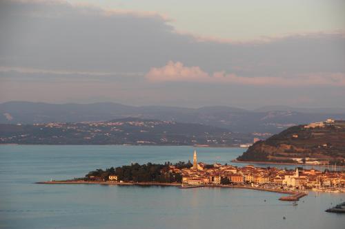 a small island in the middle of a body of water at Lighthouse.Izola in Izola