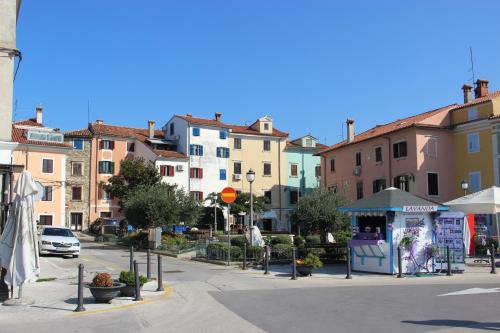 a street in a town with buildings and a street vendor at Lighthouse.Izola in Izola