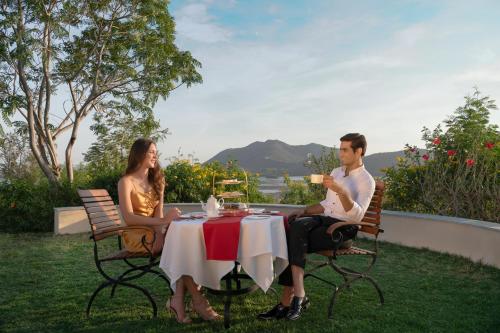 a man and a woman sitting at a table at Trident Udaipur in Udaipur