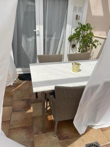 a white table with chairs and a plant on a balcony at Penthouse La Azohia Beach in La Azohía