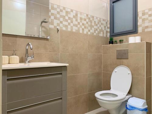 a bathroom with a toilet and a sink at Uyut apartments in Majdal Shams