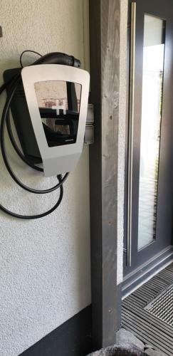 a television hanging on a wall next to a door at Eubaer Straße in Niederwiesa
