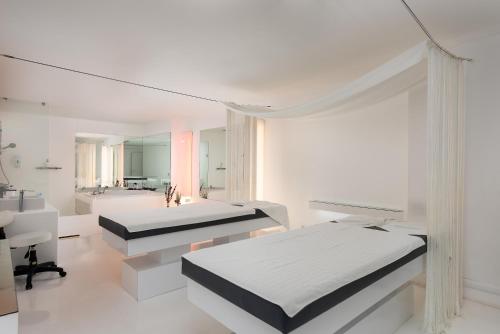 a white room with two beds and a mirror at Hotel SU & Aqualand in Antalya