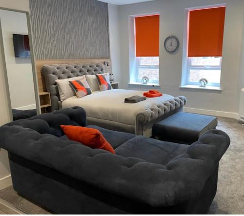 a bedroom with a bed and a couch at Mansion Court in Doncaster