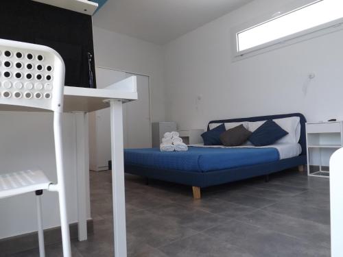 a living room with a blue couch and a table at La Dimora di Ntò in Villaggio Azzurro