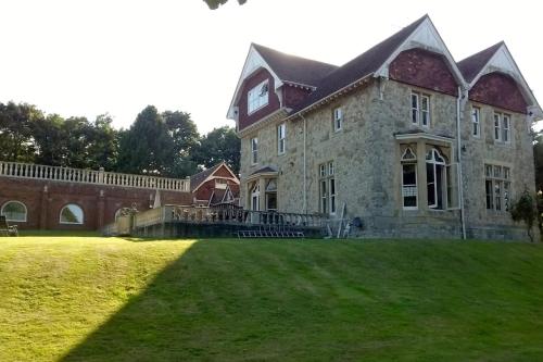 a large brick building with a clock on the side of it at Historic Manor House - Sleeps 16 - Pool & Hot Tub in Rochester