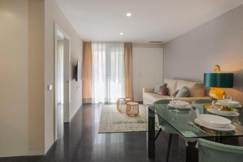 a living room with a table and a couch at Holihome Rambla 24 in Alicante
