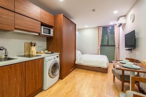 a kitchen with a washing machine in a room at 22Land Moon West Lake in Hanoi