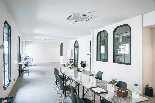a long dining room with a long table and chairs at HOMITEL Bangkok in Bangkok