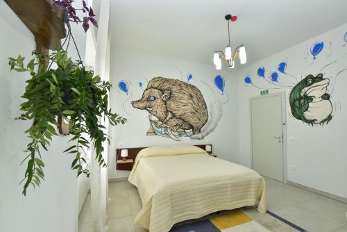 a bedroom with a bed and a mural of a bear at VAARAK in Bosa