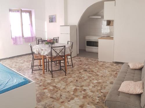 a kitchen and dining room with a table and chairs at Villa S.Antonio in Ascea