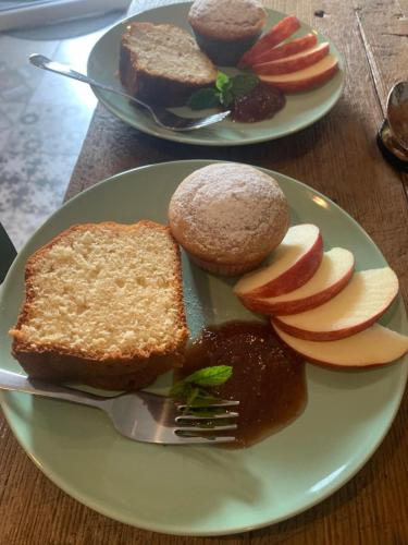 two plates of food with bread and apples on a table at Il mulino di Aurora in Dosso del Liro