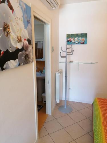 a room with a bed and a shower in a room at RESORT VILLAGE AQUA MARINA FAMILY - Daily Rooms Tidying - CocktailsBar- Pet Friendly - with Hypermarket - Delivery Restaurant-Pizzeria - Room Breakfast with supplement - Ultra Fast Wi-Fi - Play Area for children - Olympic Swimming Pool - Parking in Caorle