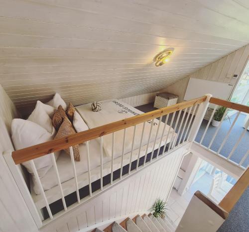 a small room with a bunk bed and stairs at Strandhaus Rügen - Meerblick, Sauna, Kamin & Whirlpool in Baabe