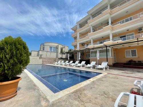 a swimming pool in front of a building at Queen Kodre Apartments in Ulcinj