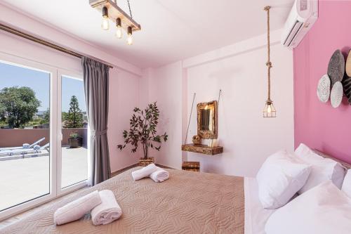 a bedroom with a large bed with two towels on it at Semiso Beach Suites in Kournás
