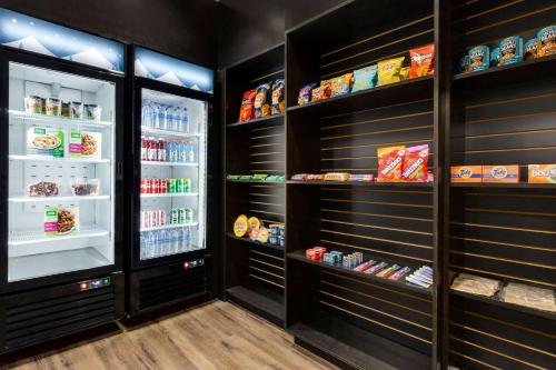 a walk in pantry with black walls and a refrigerator at Microtel Inn & Suites by Wyndham Estevan in Estevan