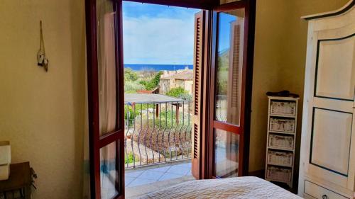 a bedroom with a door open to a balcony at Fiordaliso Aurora in Olbia