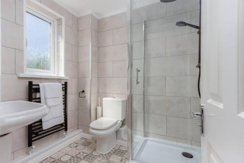 a bathroom with a toilet and a sink and a shower at Avella by the Park in Lytham St Annes