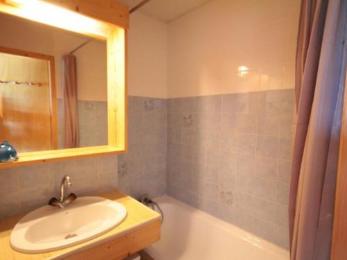 a bathroom with a sink and a mirror and a tub at Studio Les Saisies, 1 pièce, 4 personnes - FR-1-293-169 in Les Saisies