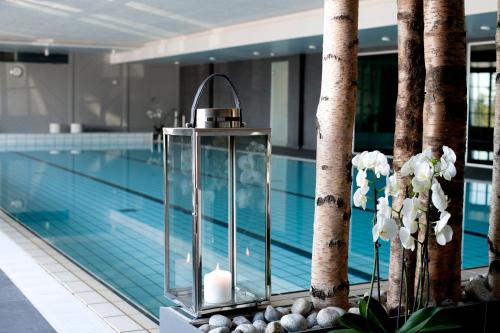 a swimming pool with a large window in the middle of it at Lysebu Hotel in Oslo
