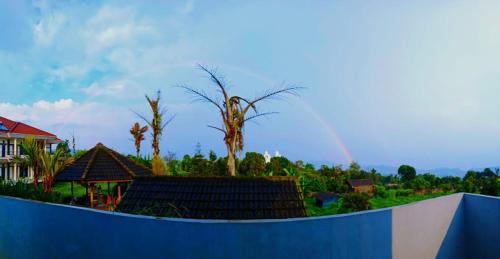 a view of a house with a rainbow in the background at Villa Lembang Syariah near park & Zoo in Lembang