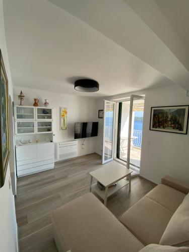 a living room with a couch and a table at Pearl of Adriatic in Dubrovnik