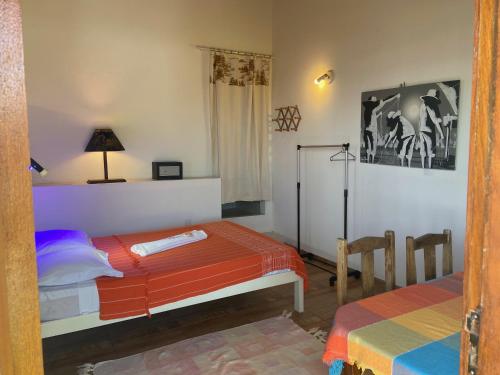 a room with two beds and a refrigerator in it at WegoKite Stars in Taíba