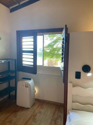 a bedroom with a bed and a window and a desk at WegoKite Stars in Taíba