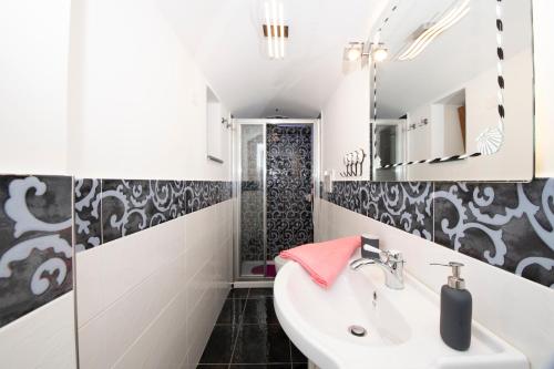 a bathroom with a sink and a mirror at La dimora del nonno...nel cuore di Amalfi in Amalfi