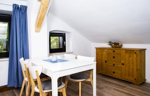 a dining room with a white table and chairs at Pension Haus Fürstenberg in Grünhain-Beierfeld
