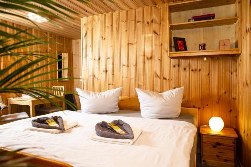 a bedroom with a bed with towels on it at Pension Haus Fürstenberg in Grünhain-Beierfeld